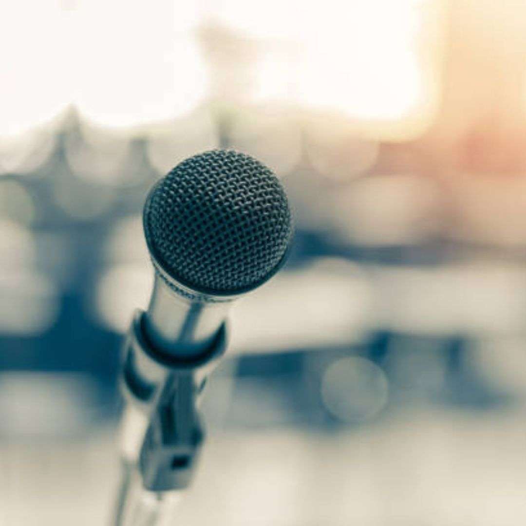Microphone on a stand in front of a microphone stand, with a blurred background, Hire Birthday Entertainment in Singapore